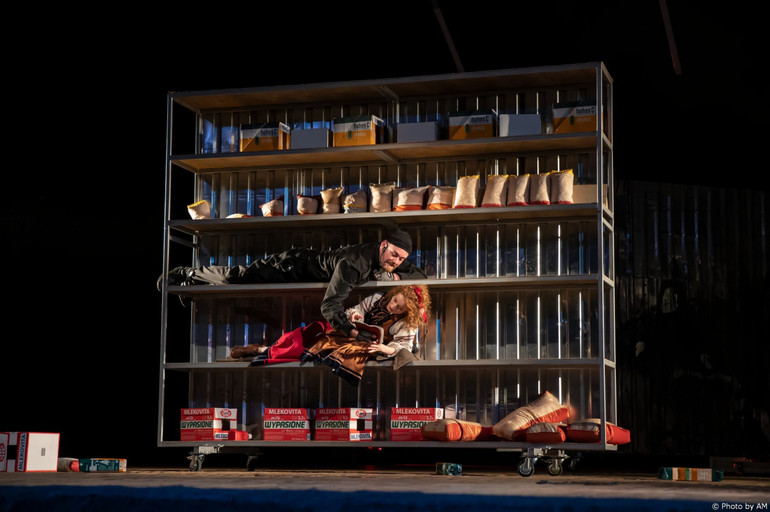 The actors play while standing on the bread racks