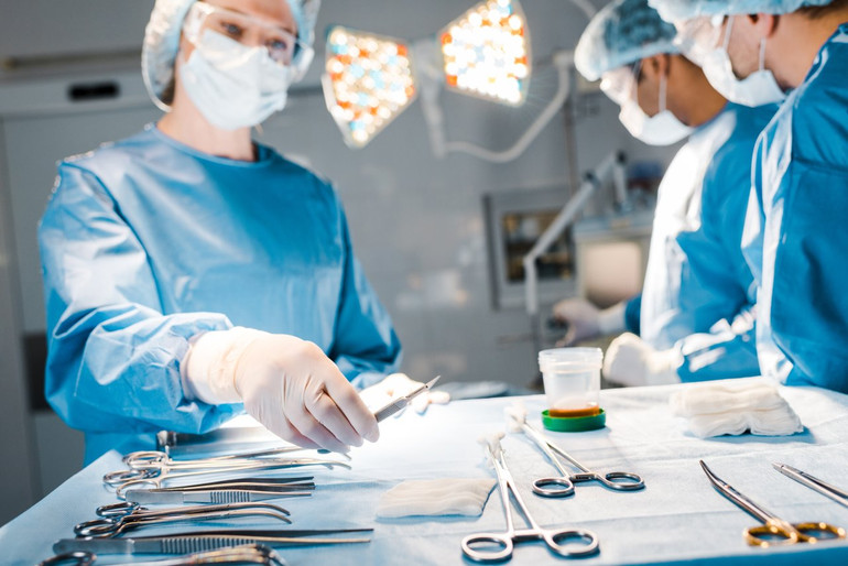 Medical workers in front of a table with instruments