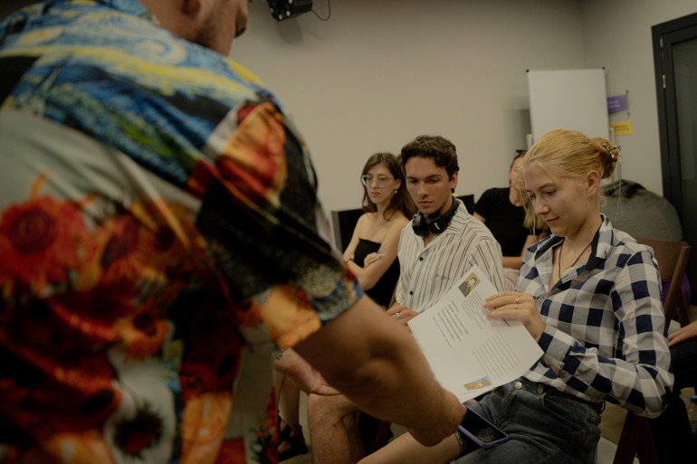 Влад роздає листочки з домашнім завданням написати вірш