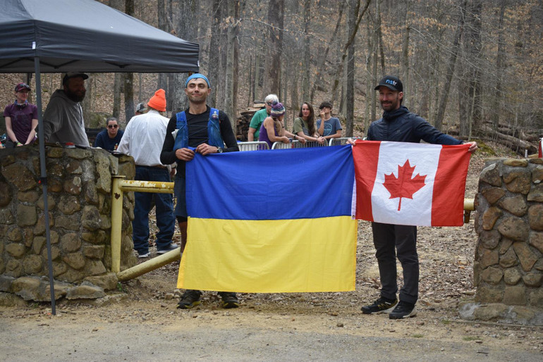 Ihor holds the flag of Ukraine at a race in Canada